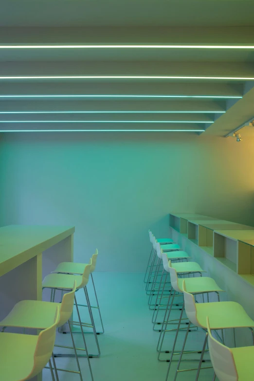 a bunch of chairs that are in a room, a digital rendering, light and space, neon standup bar, john pawson, classroom, glowing hue of teal