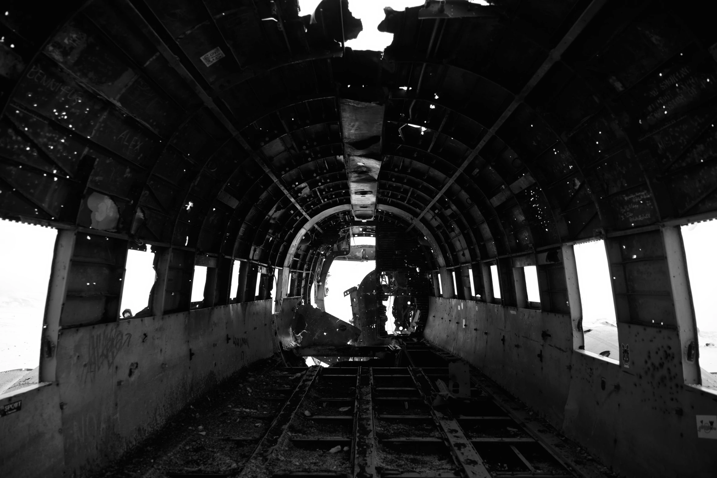 a black and white photo of the inside of a train car, by Robert Jacobsen, surrealism, flying debris, airplane cockpit, promo image, burned