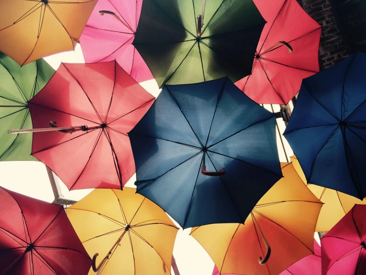 a bunch of colorful umbrellas hanging from the ceiling, a photo, trending on unsplash, precisionism, illustration”, multiple stories, alessio albi, sunny sky