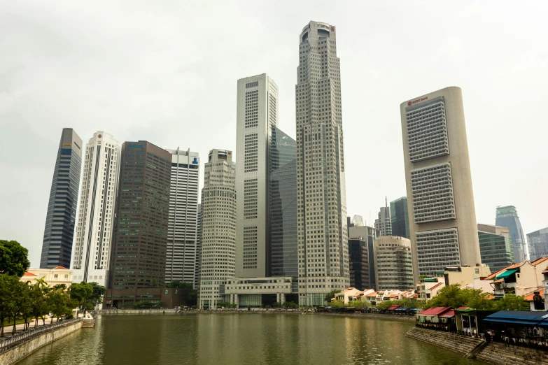 a large body of water surrounded by tall buildings, inspired by Cheng Jiasui, pexels contest winner, hurufiyya, lee kuan yew, white buildings with red roofs, brutalist appearance, seen from outside