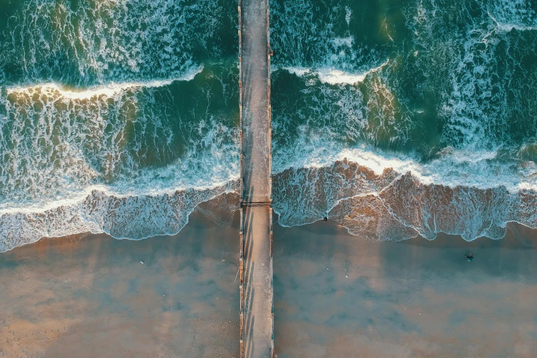 an aerial view of a bridge over a body of water, an album cover, unsplash contest winner, santa monica beach, towering waves, vertical wallpaper, boardwalk