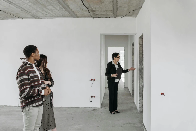 a couple of people that are standing in a room, pexels contest winner, arbeitsrat für kunst, real estate photography, white concrete floor, woman holding another woman, profile image