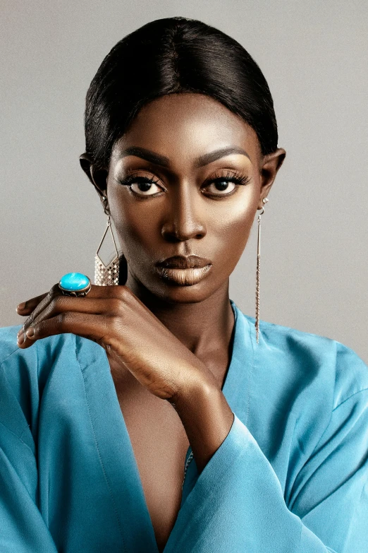 a woman in a blue dress posing for a picture, trending on pexels, afrofuturism, brown skin. light makeup, beautiful androgynous prince, 2019 trending photo, square