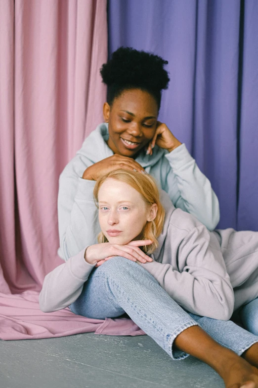 a couple of women sitting next to each other, trending on pexels, renaissance, pale pastel colours, black teenage girl, lesbian embrace, roomies