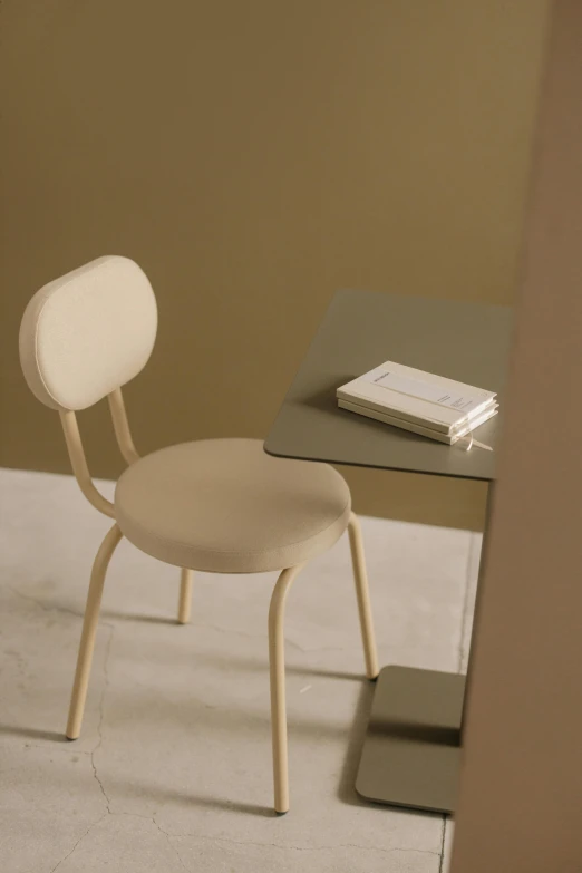 a chair sitting next to a table with a book on it, beige, design only, ultrafine detail, marshmallow