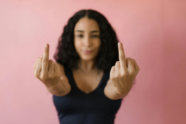 a woman making a peace sign with her fingers, trending on pexels, feminist art, light skin, no double figure, long pointy pink nose, strong woman