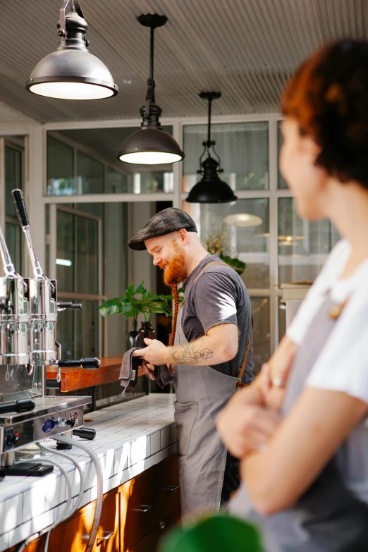 a man and a woman standing in front of a coffee machine, aussie baristas, beer, plating, bright natural light