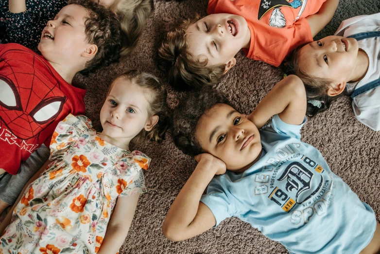 a group of children laying on the floor together, by Nina Hamnett, pexels, te pae, avatar image, toddler, diverse