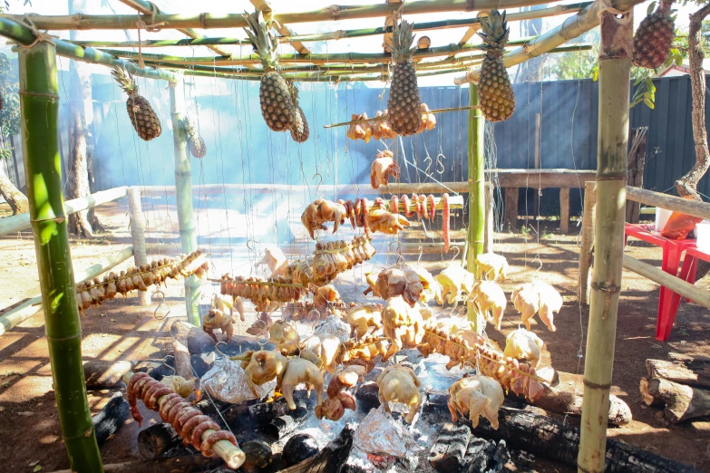 a bunch of food that is cooking on a grill, dried palmtrees, in the sun, profile image, adventure playground