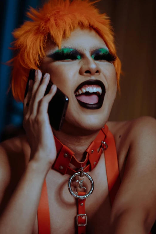 a woman with orange hair talking on a cell phone, an album cover, trending on pexels, large fangs, nonbinary model, exotic expression, 33mm photo