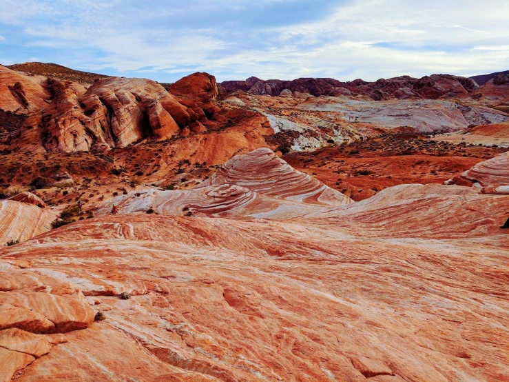 a large rock formation in the middle of a desert, by Arnie Swekel, unsplash contest winner, art nouveau, red and white colors, panoramic, colored marble, 2000s photo