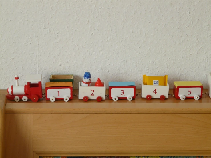 a close up of a toy train on a shelf, by The Family Circus, figuration libre, multi - coloured, small, thumbnail