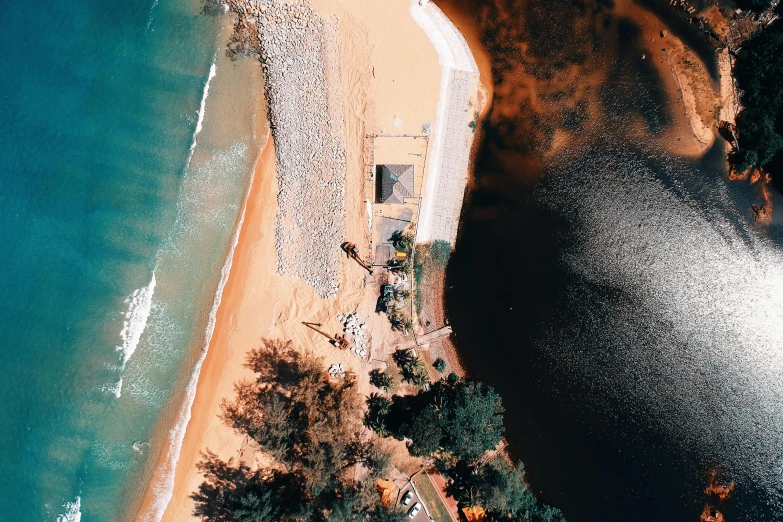 an aerial view of a beach and a body of water, by Lee Loughridge, unsplash contest winner, hurufiyya, orange and black tones, photorealistic image, manly, megalophoba