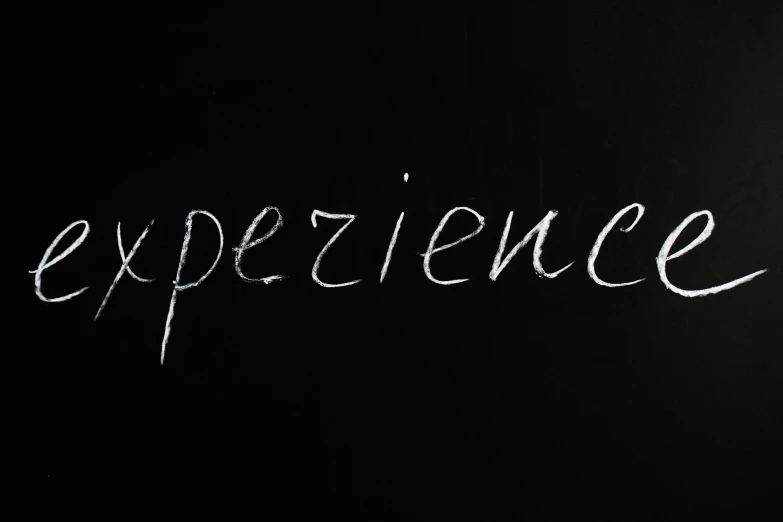 a blackboard with the word experience written on it, inspired by Adam Szentpétery, pexels, seen from below, bioluminiscence, in the world of andrew wyeth, detailed string text