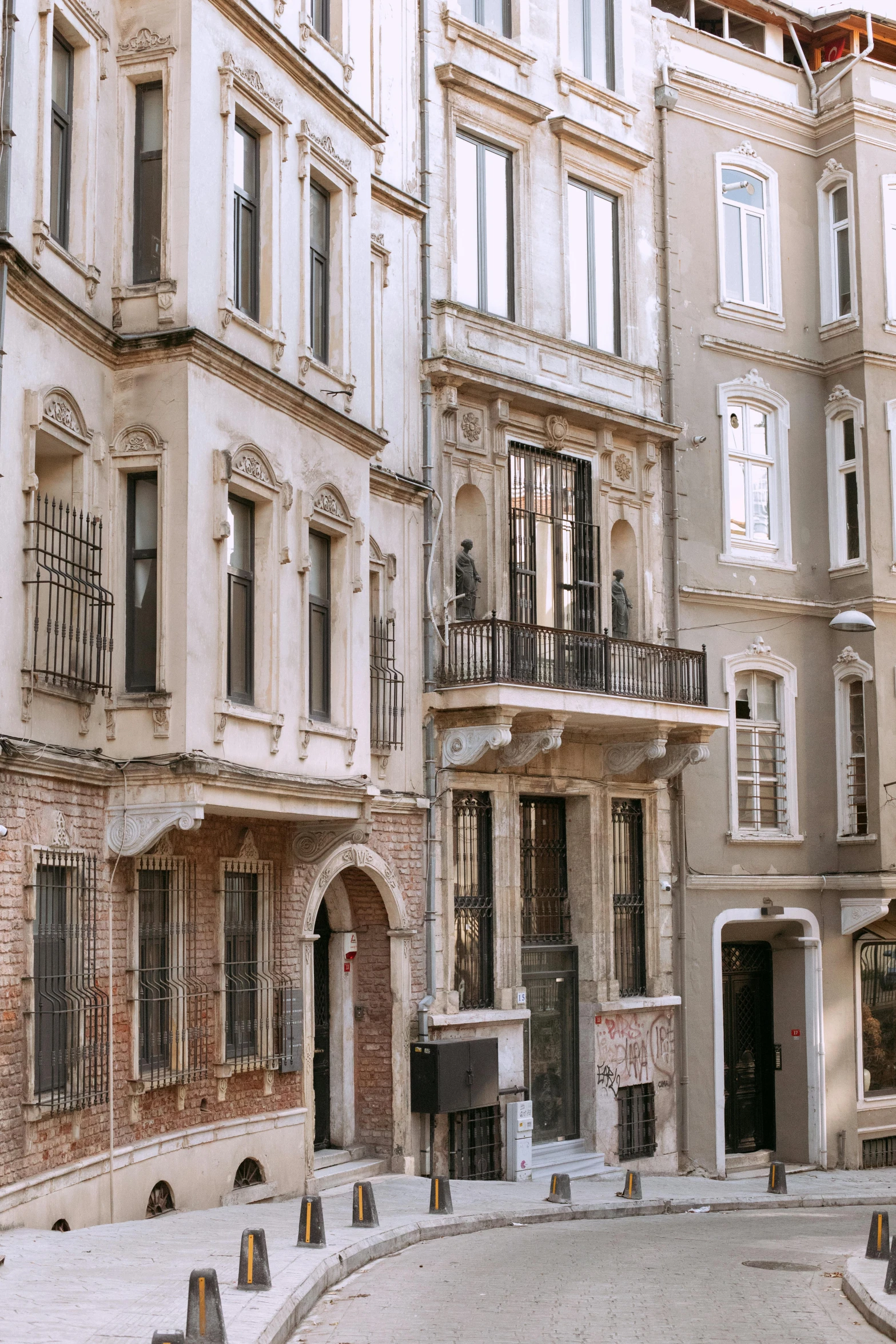 a couple of buildings that are next to each other, inspired by Nadim Karam, pexels contest winner, art nouveau, beige, istanbul, street elevation, grey