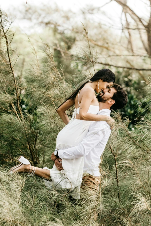 a man carrying a woman in a field, by Elizabeth Durack, pexels contest winner, happening, in a tropical forest, white, sitting in a tree, brunette