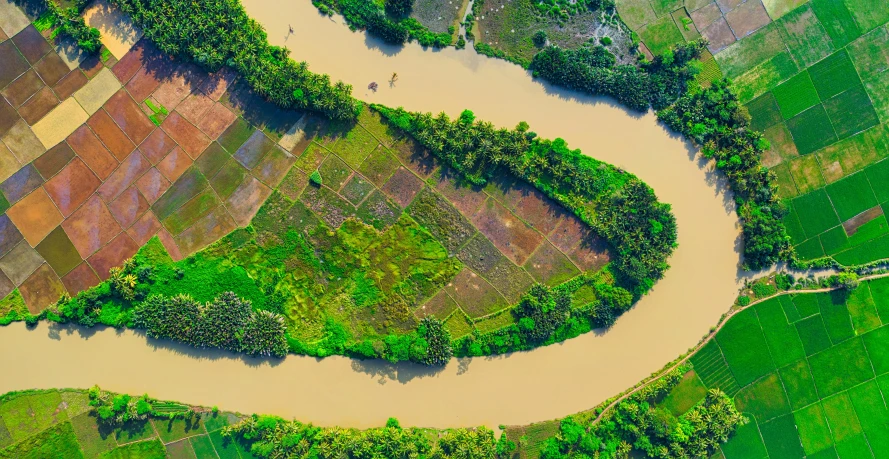 a river running through a lush green field, by Daniel Lieske, pexels contest winner, hurufiyya, satellite imagery, kerala motifs, bioremediation, thumbnail