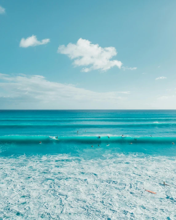 a group of people riding surfboards on top of a wave, turquoise ocean, thumbnail, as far as the eye can see, blue colours