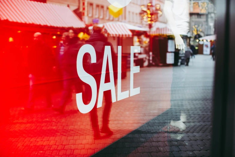 a sale sign in the window of a store, pexels contest winner, people walking around, 🎀 🧟 🍓 🧚, ecommerce photograph, thumbnail