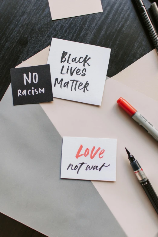 black lives matter, love not war, no racism, no racism, no racism, no racism, no racism, no racism, no racism, by Arabella Rankin, pexels, ink on post it note, 3 - piece, on a desk, “modern calligraphy art