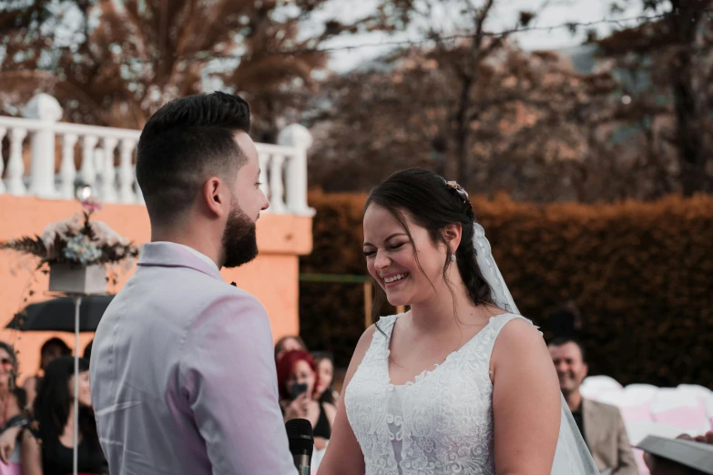 a man and a woman standing next to each other, by Robbie Trevino, pexels contest winner, happening, ceremony, smiling slightly, avatar image, half image