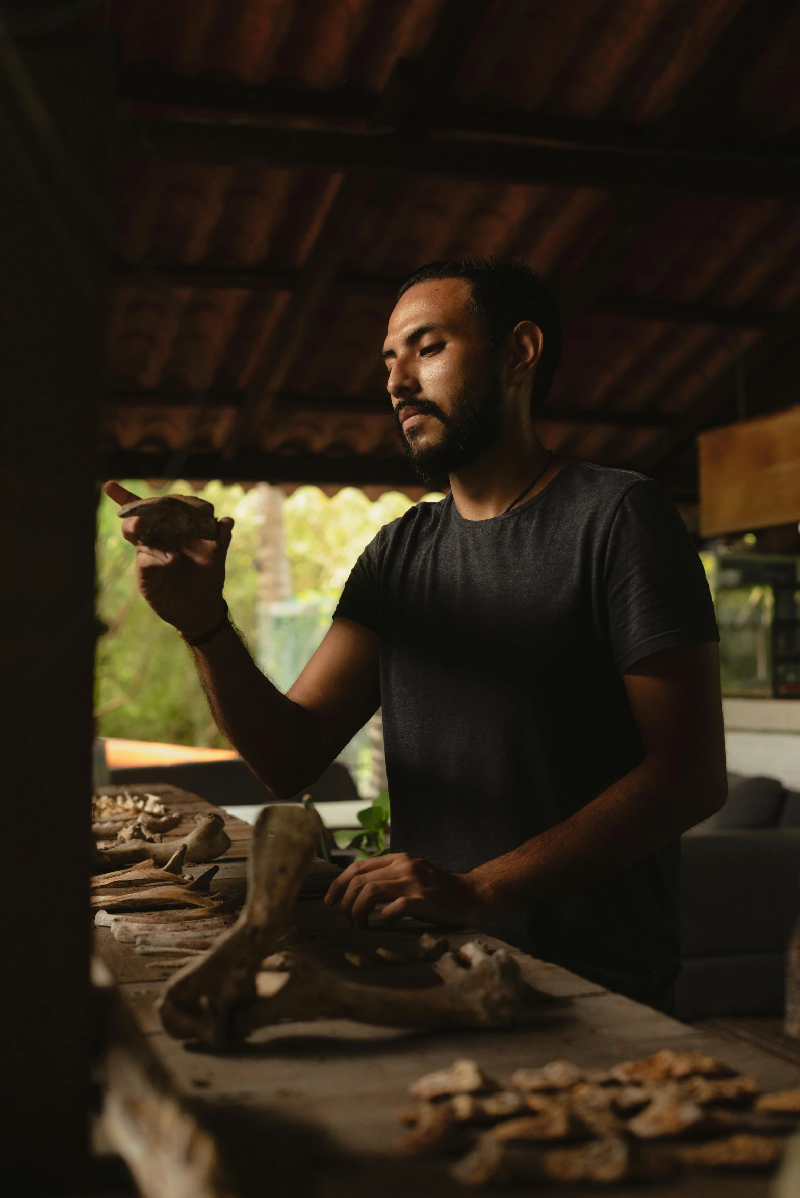 a man that is standing in front of a table, inspired by Francis Souza, pexels contest winner, archaeology, profile image, cooking show, portrait image