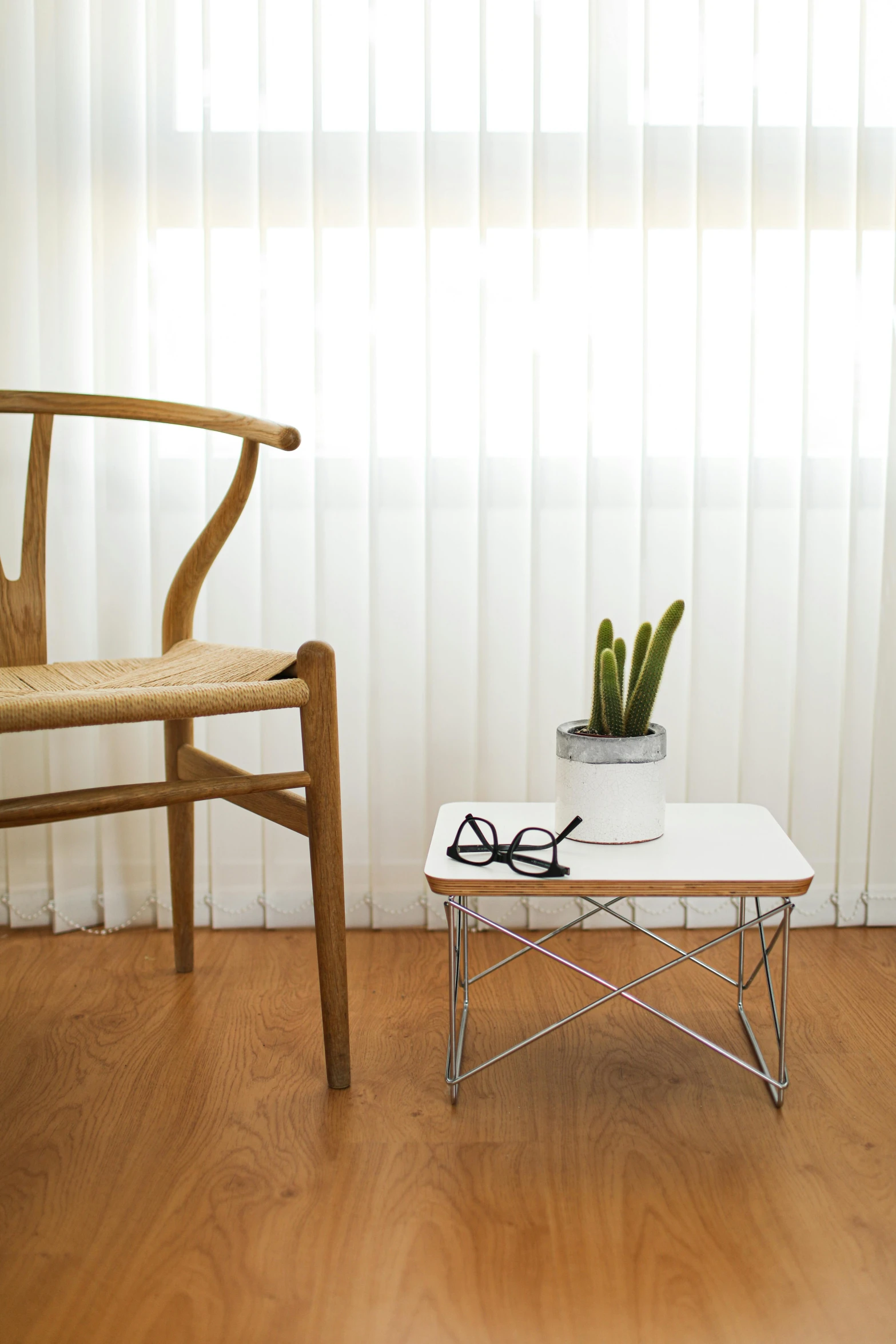 a white coffee table sitting on top of a hard wood floor, inspired by Constantin Hansen, unsplash, modernism, single chair, desert white greenhouse, origami studio 3 design, small dog