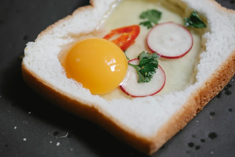 a piece of bread with an egg and radishes on it, by Adam Marczyński, trending on unsplash, fan favorite, glowing inside, koji morimoto, hot hot hot