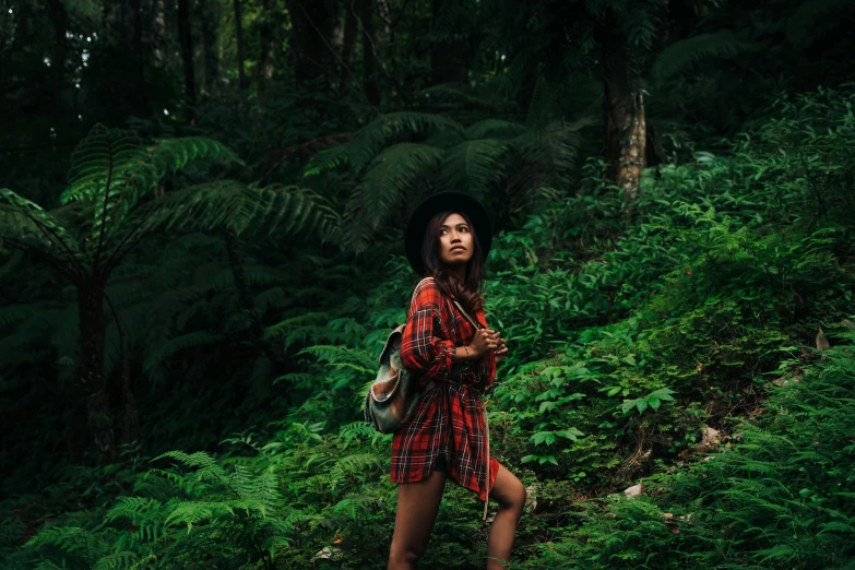 a woman standing in the middle of a forest, pexels contest winner, sumatraism, wearing a plaid shirt, avatar image, tropical jungle, lookbook