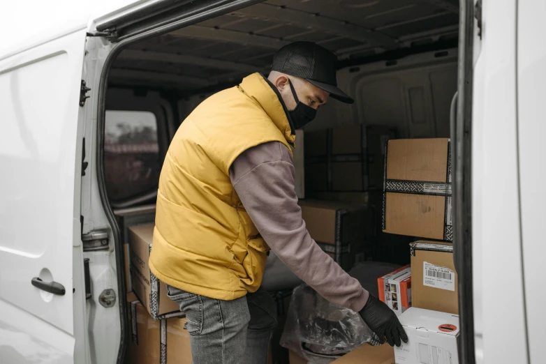 a man loading boxes into the back of a van, pexels contest winner, wearing a yellow hoodie, thumbnail, high quality material bssrdf, 6
