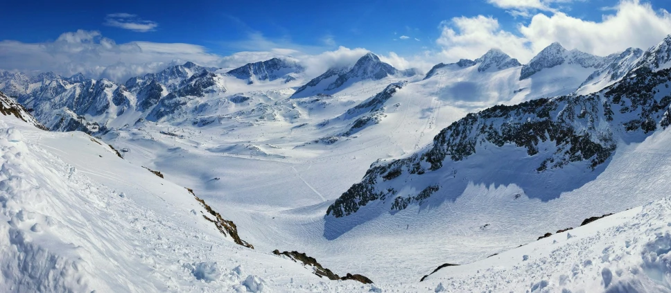 a man riding skis down a snow covered slope, by Werner Andermatt, pexels contest winner, glacier landscape, view from high, panoramic, “ aerial view of a mountain