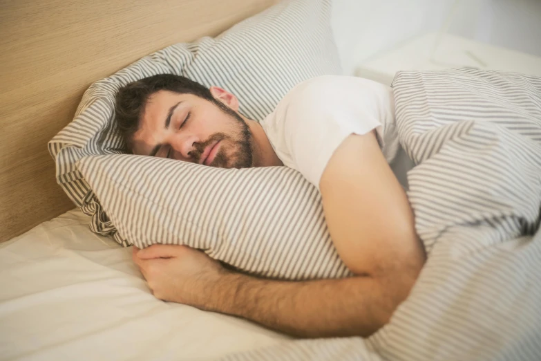 a man sleeping in bed with his eyes closed, by Julia Pishtar, pexels, fan favorite, h3h3, rectangle, striped