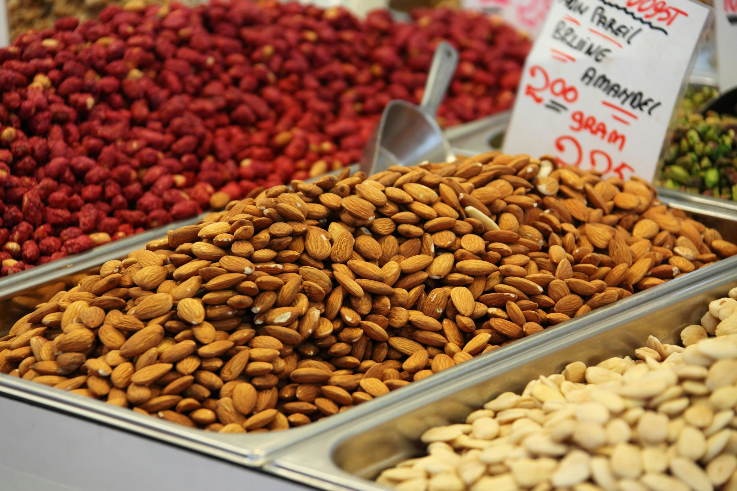 a display case filled with lots of different kinds of nuts, pexels, 💋 💄 👠 👗, colored market stand, smooth in _ the background, thumbnail