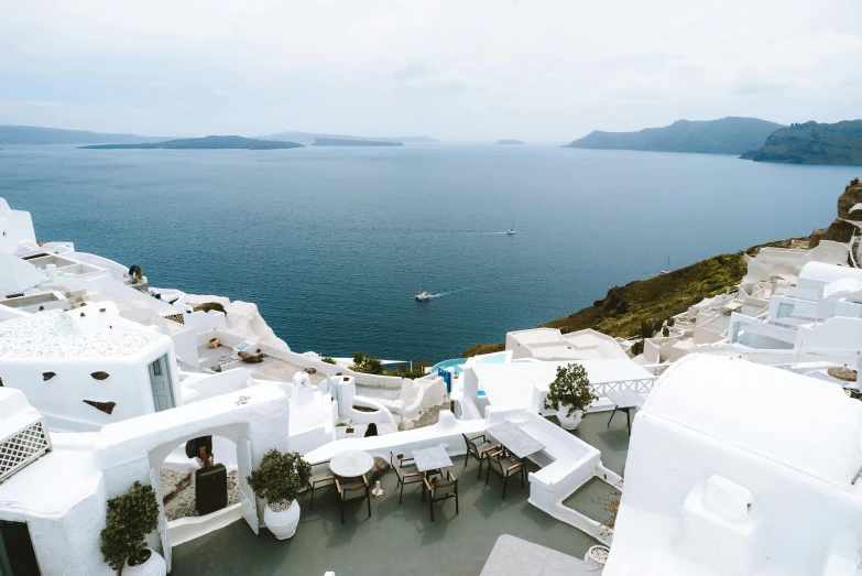 a view of the ocean from the top of a building, pexels contest winner, greek style, white houses, crater lake, slide show