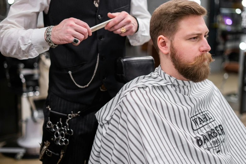 a man getting his hair cut at a barber shop, pexels contest winner, short dark blond beard, thumbnail, part leyendecker style, lachlan bailey