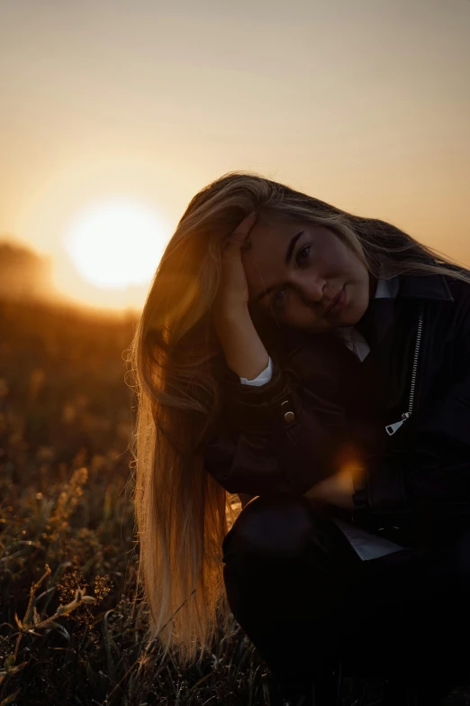 a woman sitting in a field at sunset, inspired by Elsa Bleda, trending on pexels, handsome girl, blonde, 🤤 girl portrait, struggling