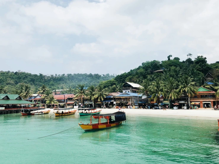 a group of boats floating on top of a body of water, by Carey Morris, pexels contest winner, sumatraism, in a beachfront environment, cambodia, avatar image, colourfull