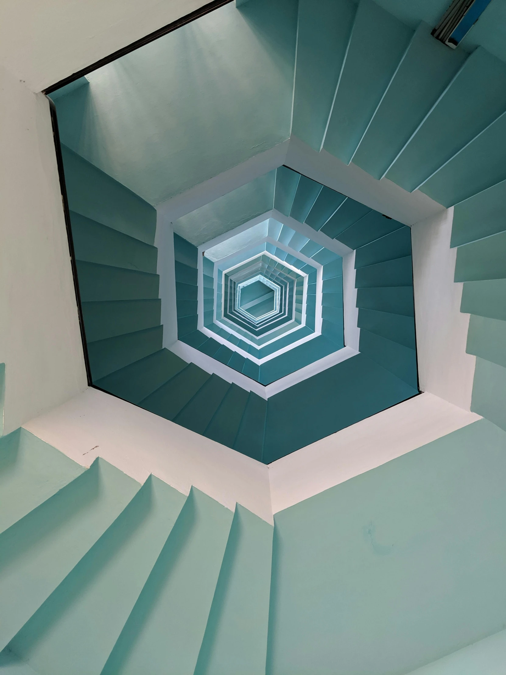 a close up of a spiral staircase in a building, inspired by M. C. Escher, unsplash contest winner, op art, teal paper, hexagons in the sky, clemens ascher, high view