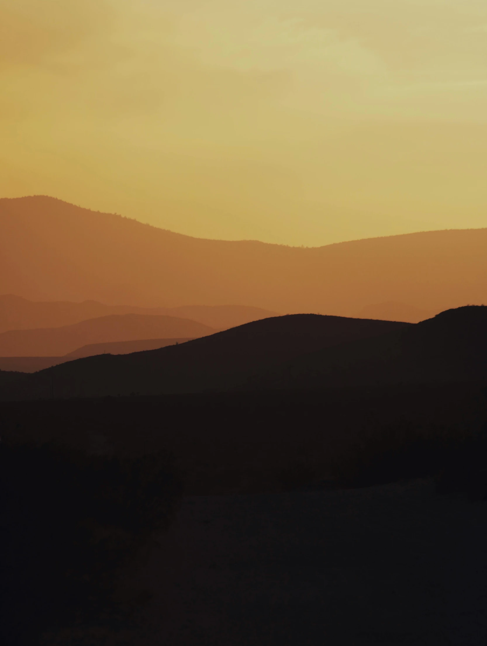 a silhouette of a person standing on top of a hill, a matte painting, pexels contest winner, tonalism, desert colors, with rolling hills, golden hour closeup photo, from 8 k matte