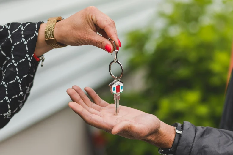 a person handing a house key to another person, pexels contest winner, photorealism, multicoloured, épaule devant pose, press shot, instagram post