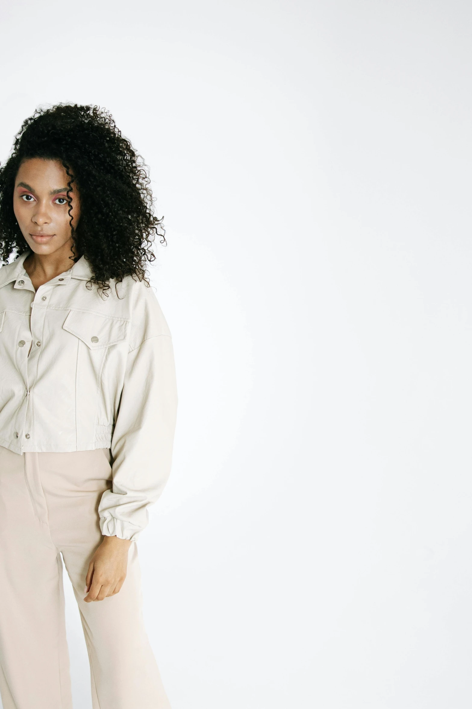 a woman in a white shirt and beige pants, an album cover, trending on unsplash, wearing a jeans jackets, on white background, puff sleeves, white soft leather model