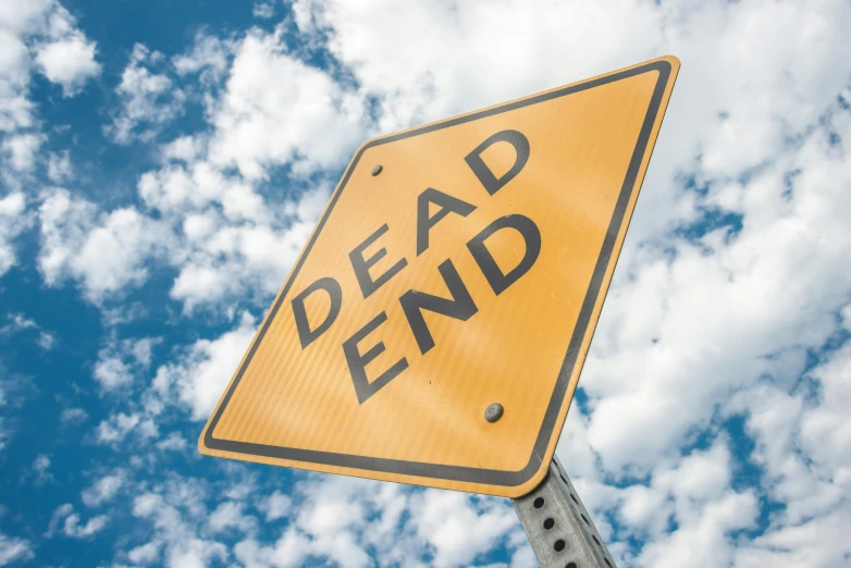 a dead end sign sitting on top of a metal pole, by David Donaldson, shutterstock, happening, bedhead, instagram post, endings, wide high angle view