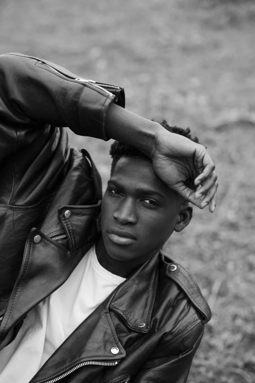 a black and white photo of a man in a leather jacket, inspired by Theo Constanté, black teenage boy, brown skin like soil, pastel', photograph taken in 2 0 2 0