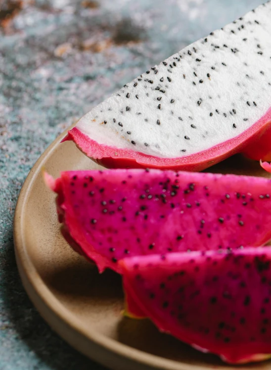 a close up of a plate of fruit on a table, pink and black, luscious with sesame seeds, 6 pack, seeds