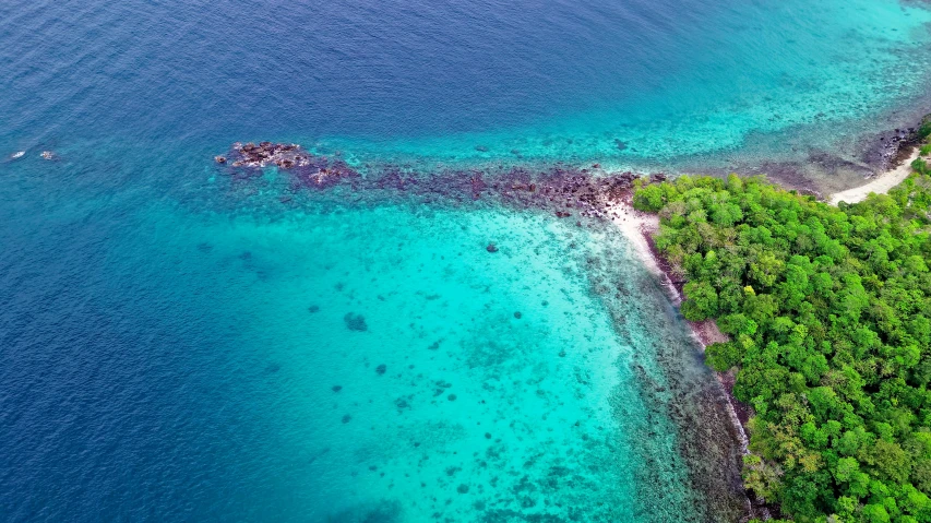 an aerial view of an island in the middle of the ocean, pexels contest winner, delicate coral sea bottom, thumbnail, 8k 4k, monsoon on tropical island