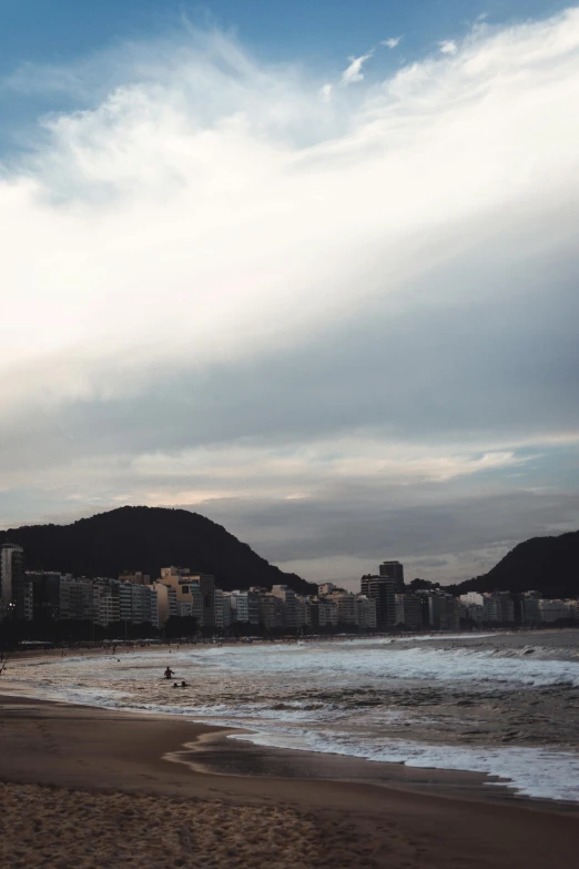 a man flying a kite on top of a sandy beach, a picture, by Elsa Bleda, entire city in view, oscar niemeyer, surfing, location ( favela )