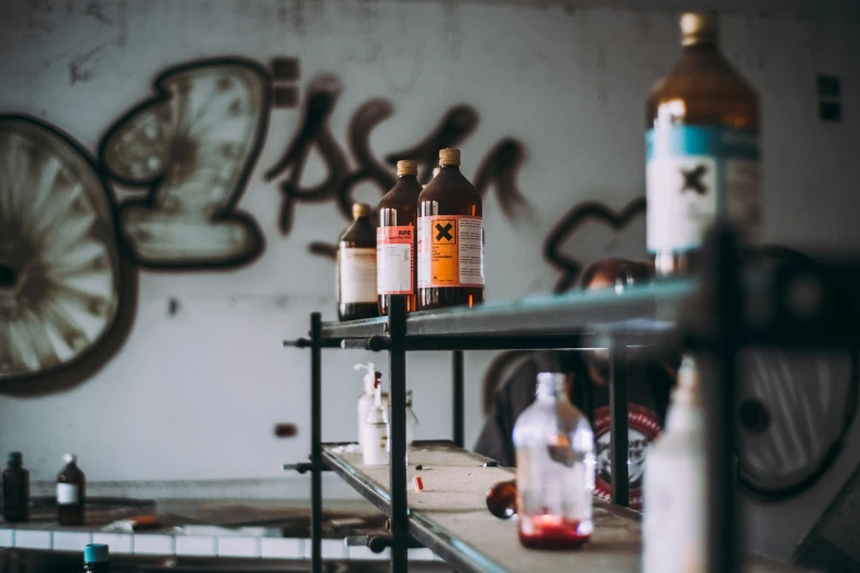 a bunch of bottles that are on a shelf, pexels contest winner, graffiti, stood in a lab, middle shot, some rust, mixing drinks