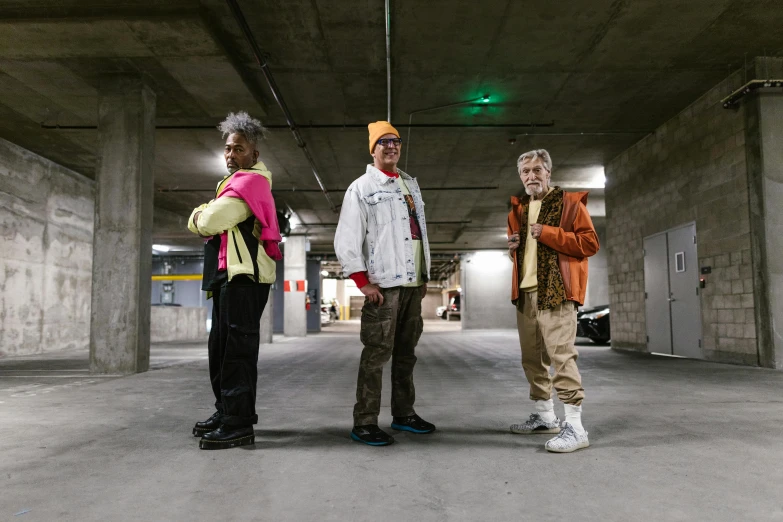 three men standing next to each other in a parking garage, by Dan Frazier, dressed as a scavenger, woman in streetwear, multicoloured, ashteroth