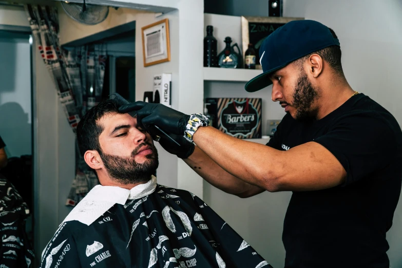 a man getting his hair cut at a barber shop, pexels contest winner, les nabis, with leonidas beard, with facial tattoo, thumbnail, slicked black hair