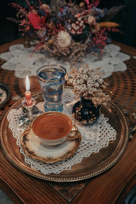 a close up of a plate of food on a table, inspired by Elsa Bleda, pexels contest winner, renaissance, hot cocoa drink, ottoman miniature style, candlelight, vintage old